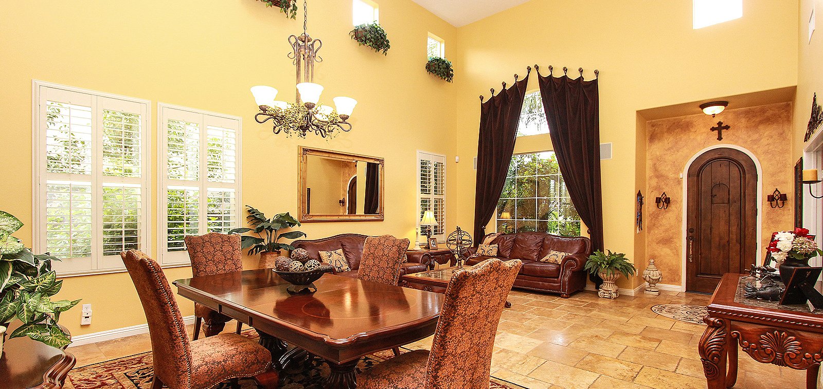 THE HENSLEY GROUP REAL ESTATE - well lit dining and living room w/ high ceiling and chandelier